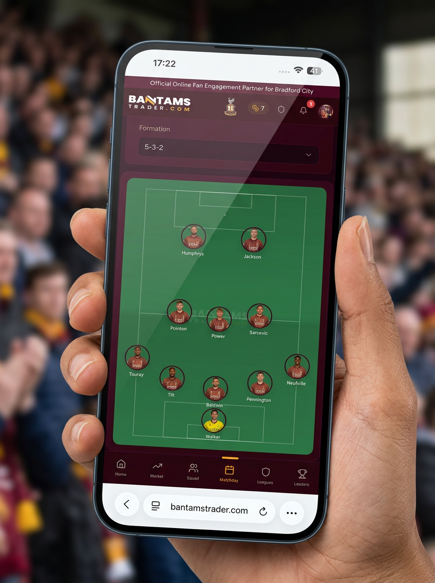 Bradford City supporter holding a phone showing the Bantams Trader squad selector